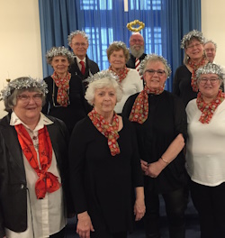 Ten church members with tinsel halos on their heads.