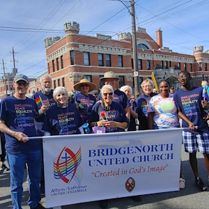 Group of church members in Pride parade with BUC sign