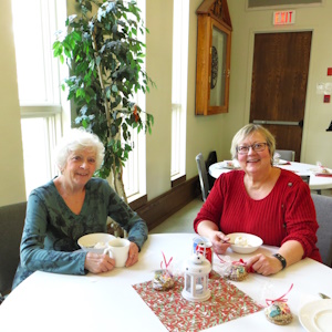 Wendy Dunits and Rev Cathy Gradante sitting at a table